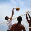 man in white shorts playing volleyball during daytime